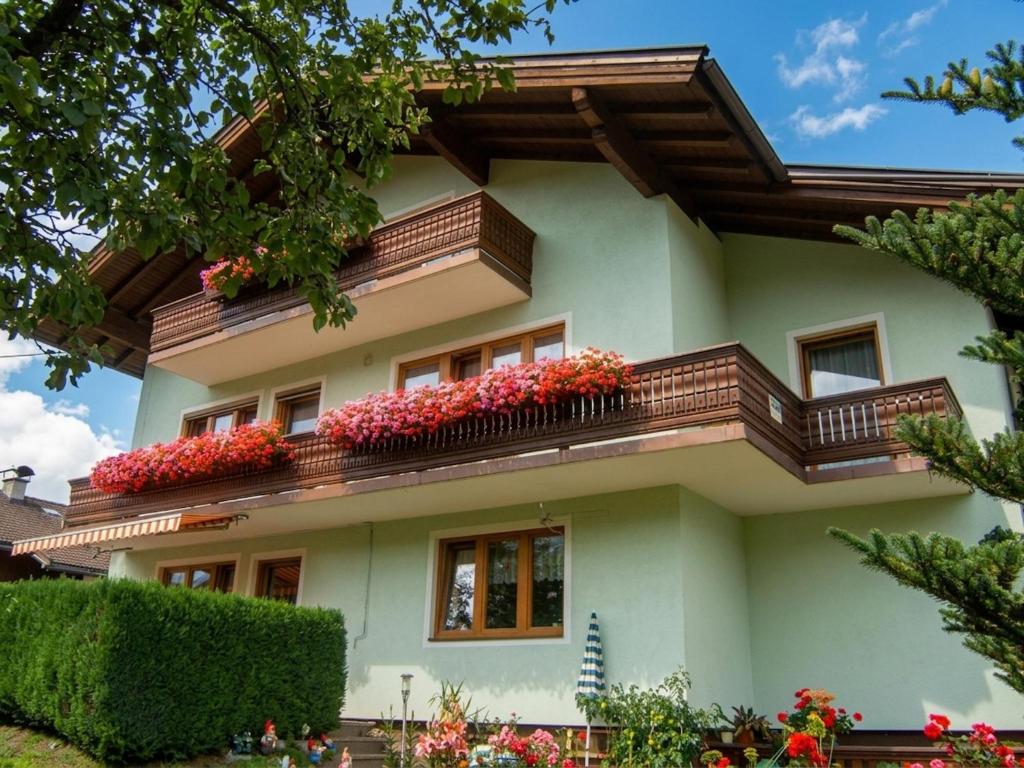 a house with flowers on the balconies at Nussbaumer in Niedernsill