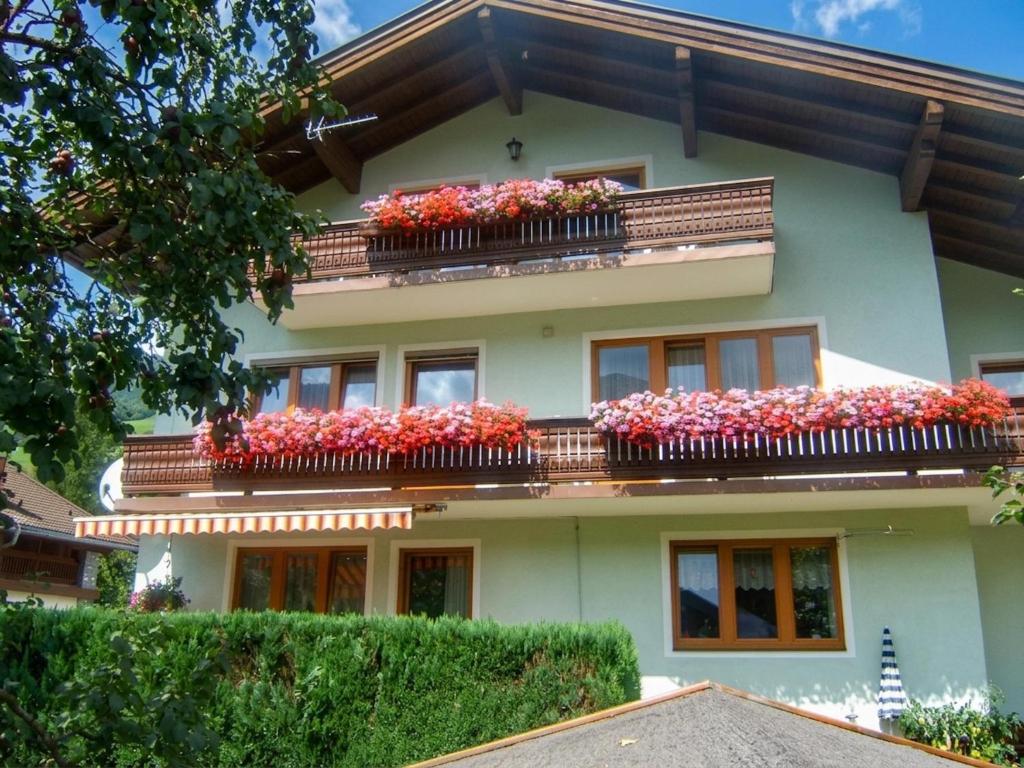 a building with flower boxes on the balconies at Nussbaumer S in Niedernsill