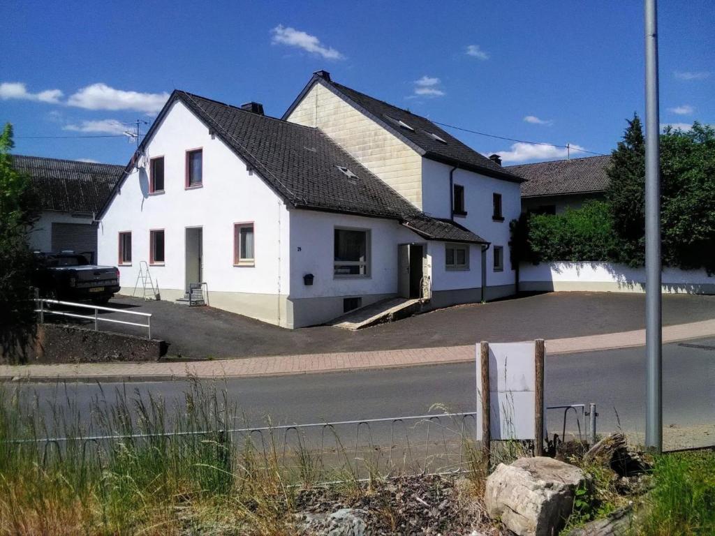 a white house on the side of a street at Großlangenfeld in Großlangenfeld