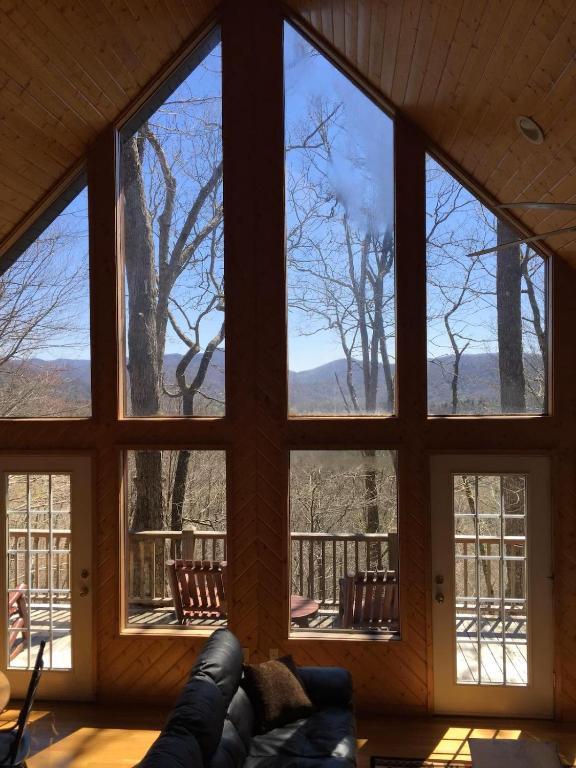 a room with large windows with a view of the mountains at Further Up & Further In in Topton