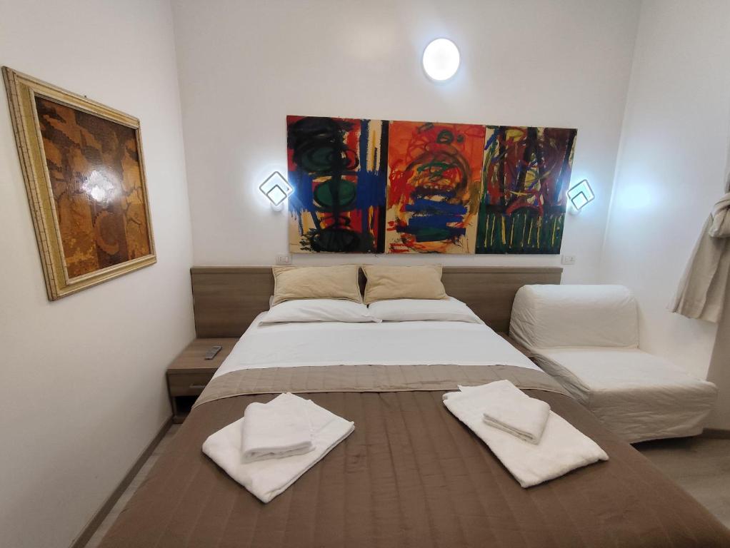 a bedroom with a bed with two towels on it at Art And Relax Suites in Rome