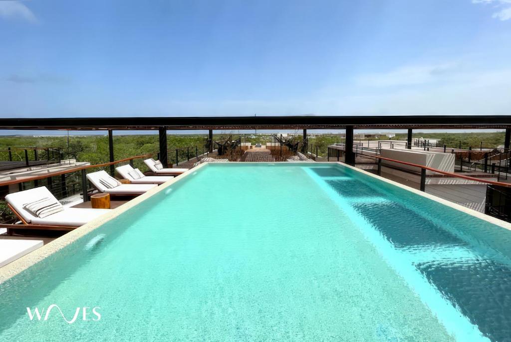 a swimming pool on top of a building at Amelia By Waves in Tulum
