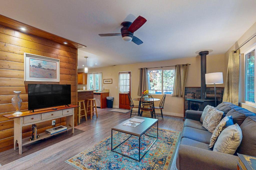 a living room with a couch and a flat screen tv at Casa Tahquitz in Idyllwild