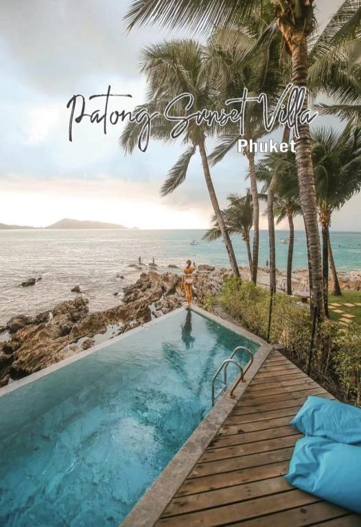 a pool on the beach with a woman standing next to it at patong sunset villa Phuket in Patong Beach