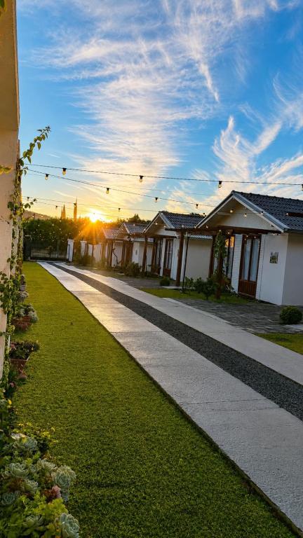 a row of houses with the sunset in the background at Pousada Dom Pietro in Urubici