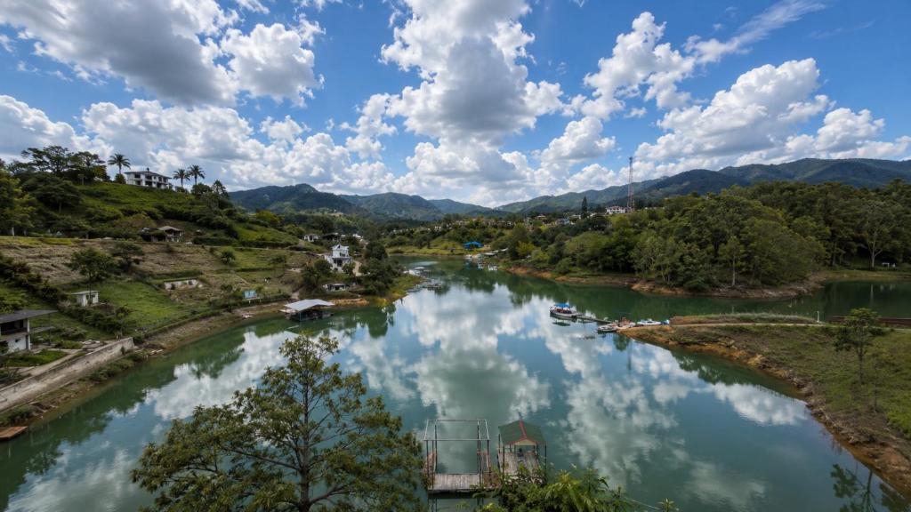 a river with boats in it under a cloudy sky at Springfield Ecoloft- Guatapé in Guatapé