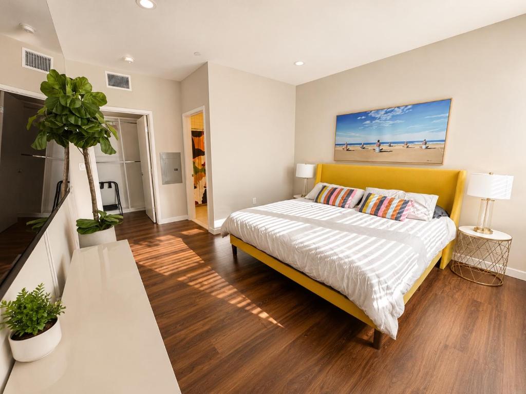 a bedroom with a bed with a yellow headboard at Spacious, Comfortable, and Central Condo in Los Angeles