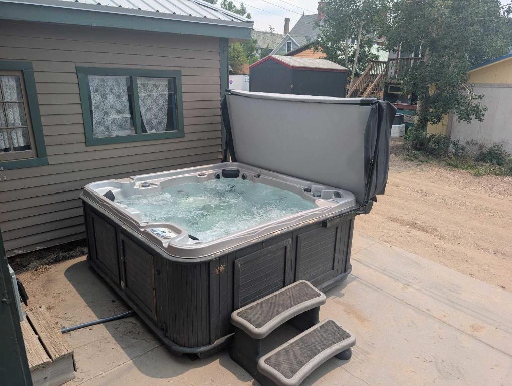 a hot tub sitting outside of a house at Governor's Mansion beautiful 3bd with pool table in Leadville