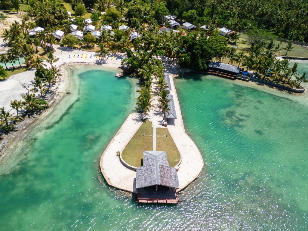 an aerial view of a resort in the water at E' Nauwi Beach Resort in Port Vila