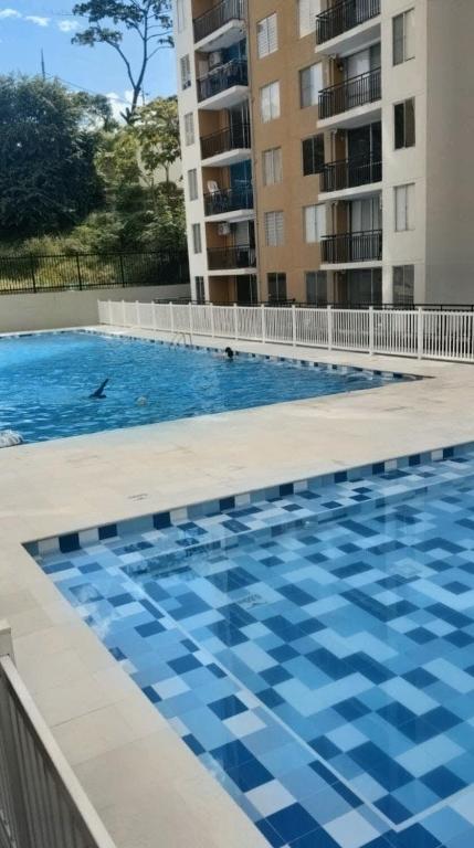 a swimming pool in front of a building at Apartamento en Melgar con la mejor ubicacion in Melgar