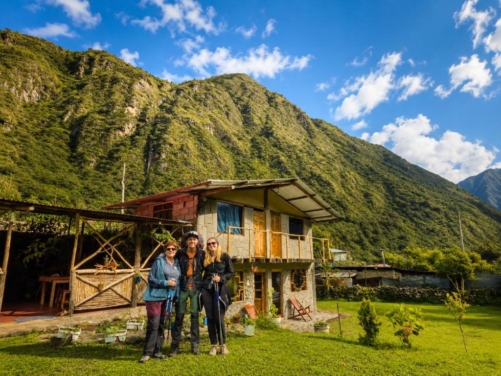 a group of people standing in front of a house at Salkantay Wasi in Colcapampa