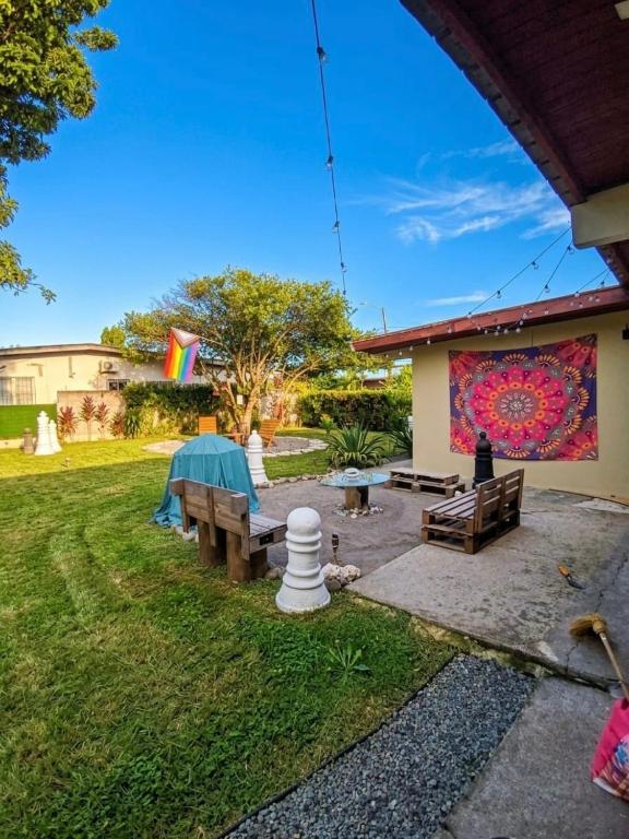a backyard with benches and a painting on the wall at Penny House Hostal in David