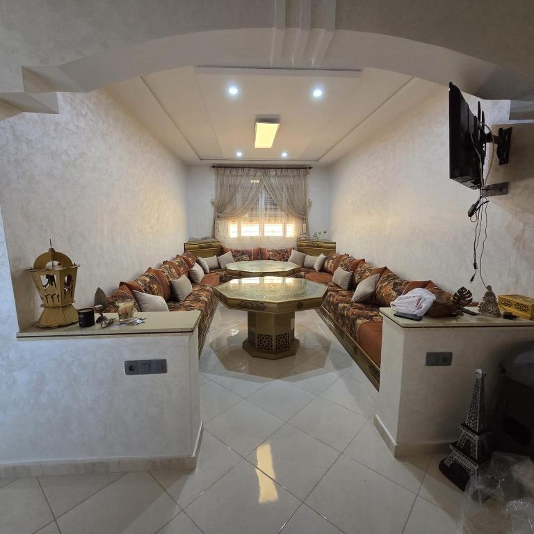 a living room with a couch and a table at Lmadghri6 in Ras El Ma