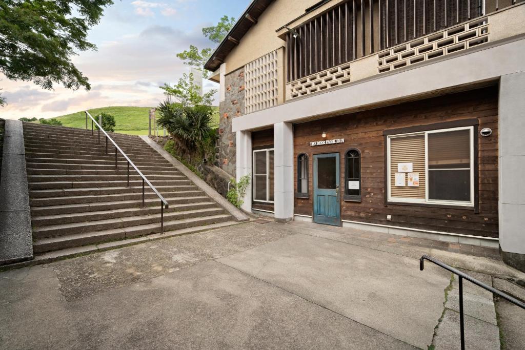 a stairway leading to a building with a blue door at The Deer Park Inn in Nara