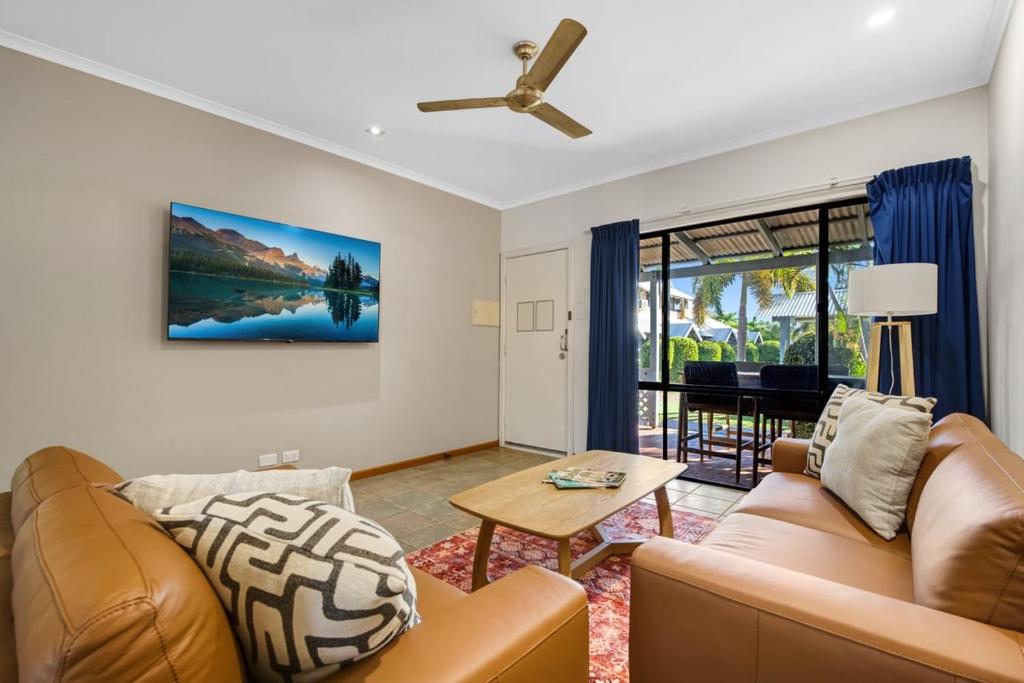 a living room with a couch and a table at Dunes Escape in Broome