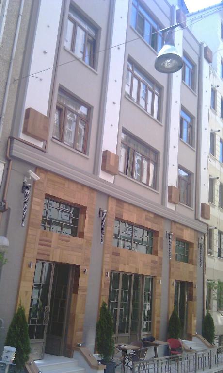 a building with tables and chairs in front of it at Collage Pera Hotel in Istanbul