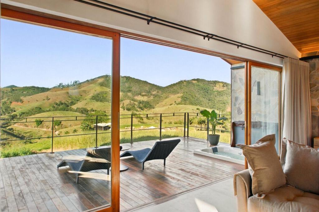 a living room with a view of the mountains at Casa ALPIN in São José dos Campos