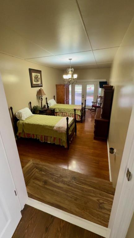 a bedroom with two beds and a desk in a room at The Pecan House in Bainbridge