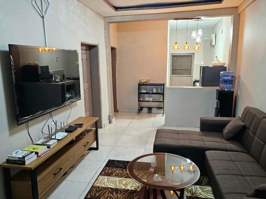 a living room with a couch and a table at This apartment blends elegance and calm in Mills Center
