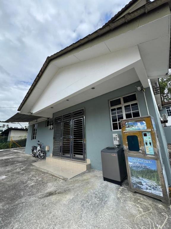 a house with a motorcycle parked in front of it at Skudai Sojourn in Skudai