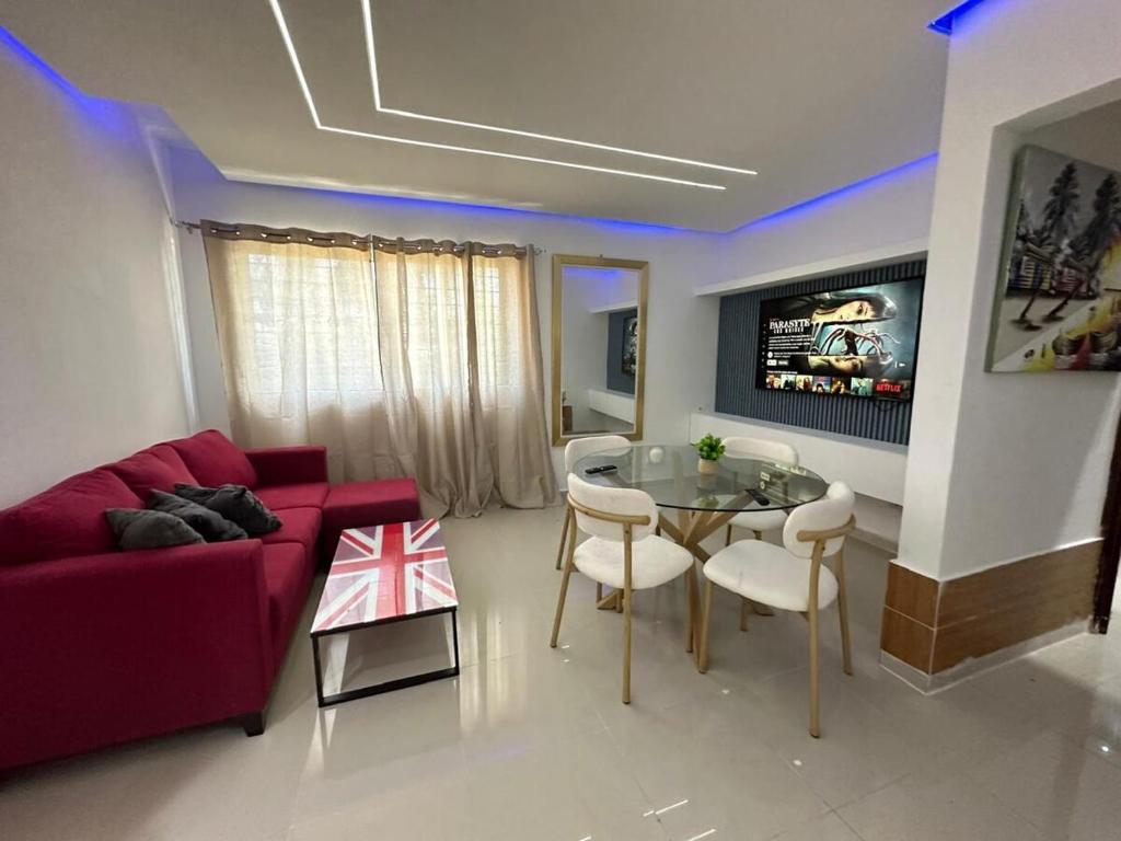 a living room with a red couch and a table at Ts02 torre B in La Romana