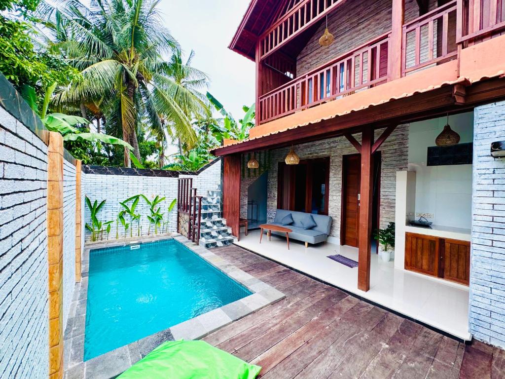 a swimming pool in the backyard of a house at Dtegal Private Villa in Klungkung