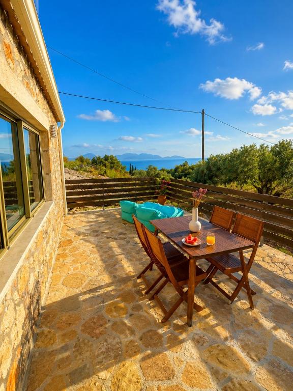 a table and chairs on a patio with a view at Sea salt house in Zambelláta