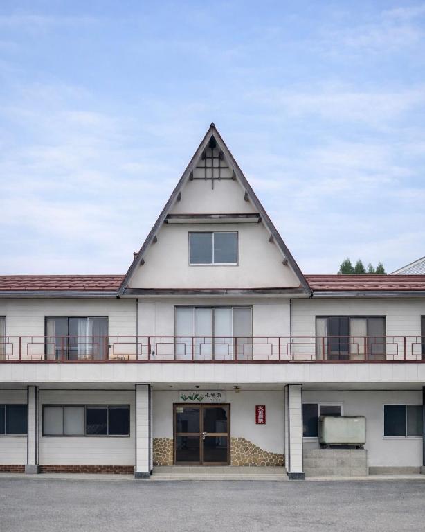 an exterior view of a building with a triangular roof at Mizubaso in Gujo