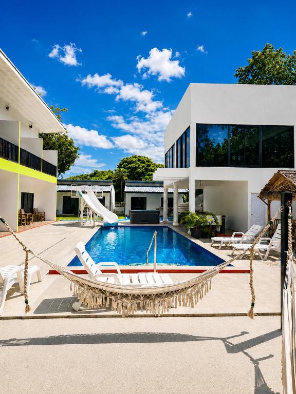 a swimming pool in the backyard of a house at Samui Hills Resort in Taling Ngam Beach