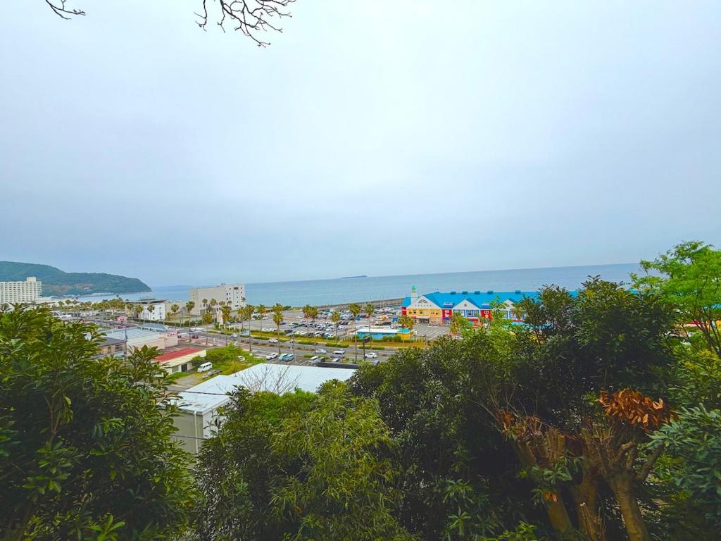 a view of a city with the ocean in the background at Harbor Terrace Izu OceanView in Ito
