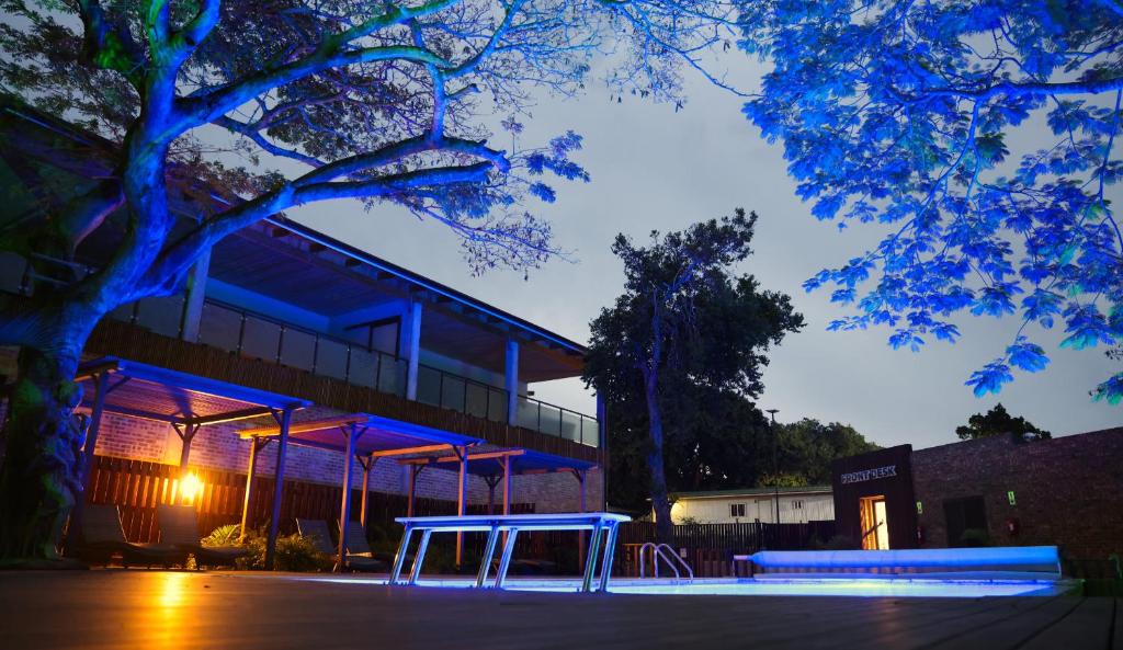 a blue bench in front of a building at night at Big Blue Sodwana Bay in Sodwana Bay