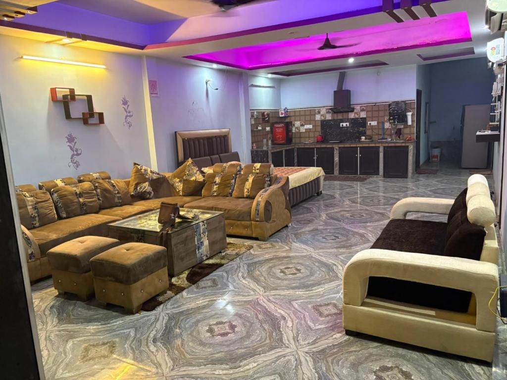a large living room with couches and a table at Dixit's Villa in Kānpur