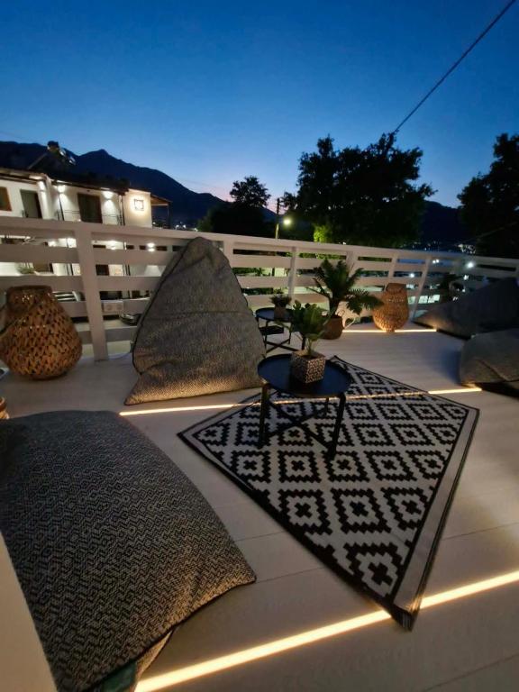 a patio with pillows and a potted plant on it at Summer House Moschovi in Skala Potamias