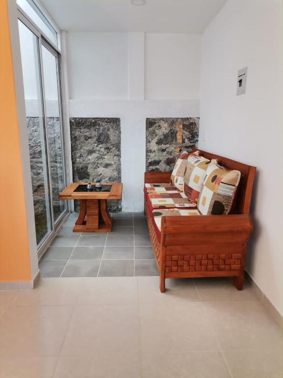a living room with a couch and a table at Loft los Colibries 6 parking option in Tlaxcala de Xicohténcatl