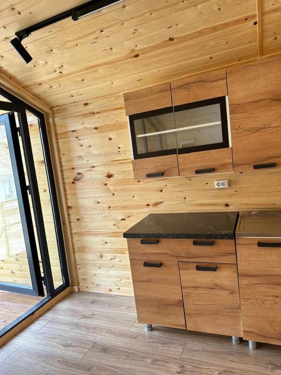 a room with a wooden wall with a counter top at Барнхаус in Cholpon-Ata