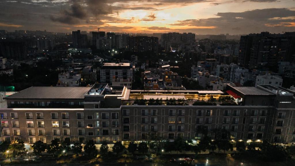 a view of a city at night with a building at Orchid Parc Bengaluru - Manyata Business Park in Bangalore