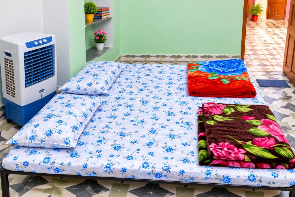 a bed in a room next to a heater at The Heritage Eco Stay in Bikaner