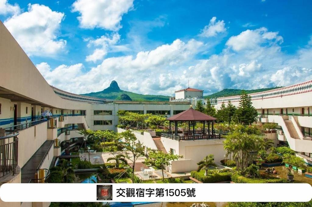 a view of a resort with a mountain in the background at Howard Beach Resort Kenting in Kenting
