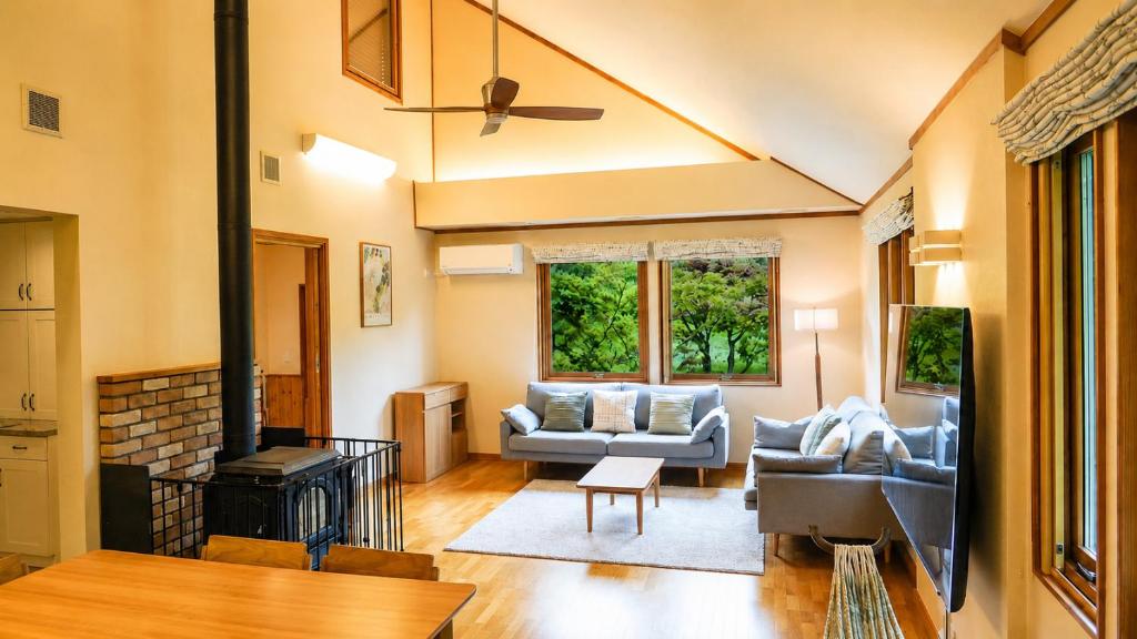 a living room with two couches and a fireplace at Lilla nasu in Nasu