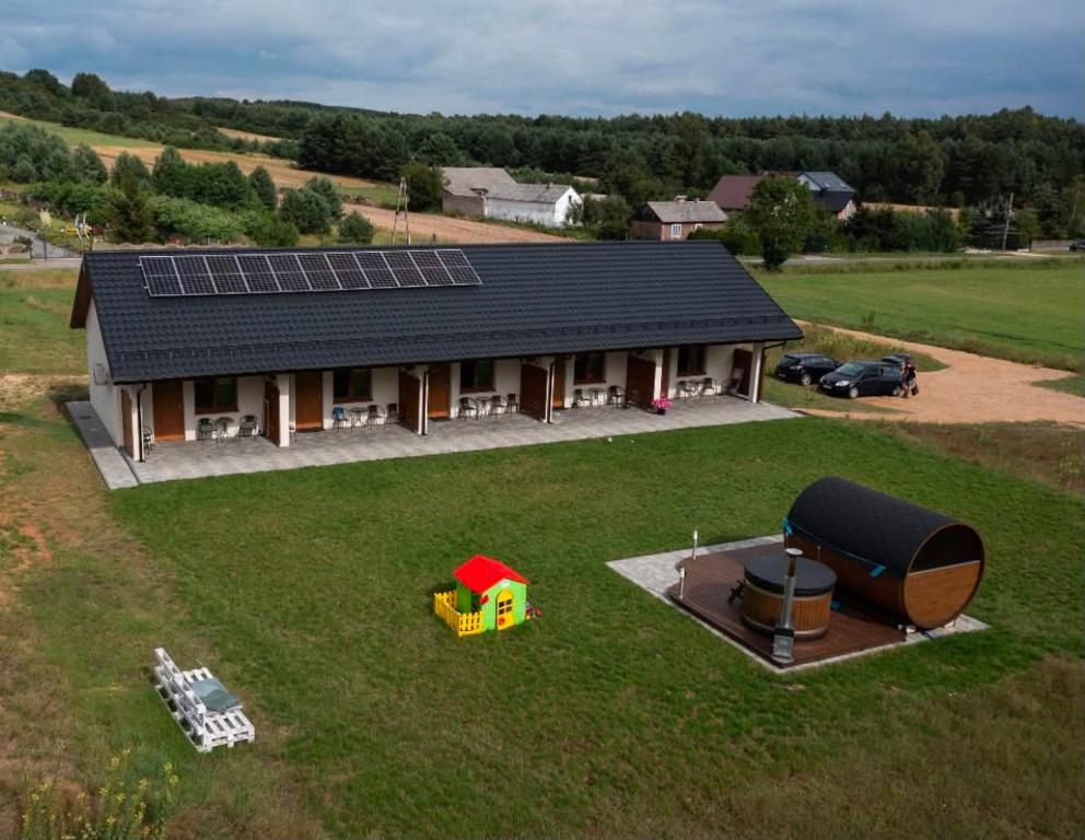 an aerial view of a house with solar panels on it at Leśne Apartamenty in Bobolice