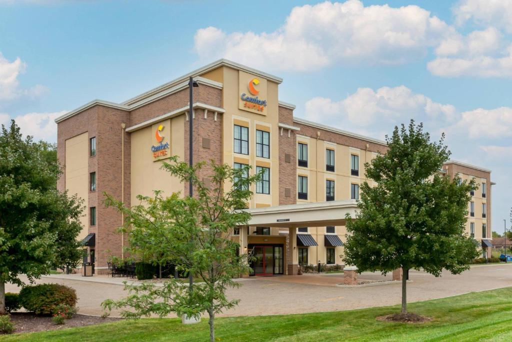 an office building with trees in front of it at Comfort Suites Hartville-North Canton in Uniontown