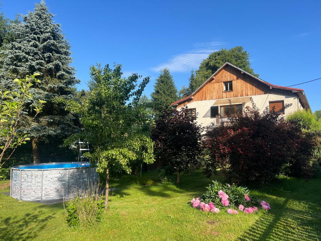 a house with a swimming pool in a yard at Apartmán Renata in Rudník