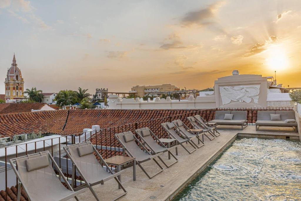 a rooftop patio with lounge chairs and a swimming pool at Hotel Casa Don Luis by Faranda Boutique, a member of Radisson Individuals in Cartagena de Indias