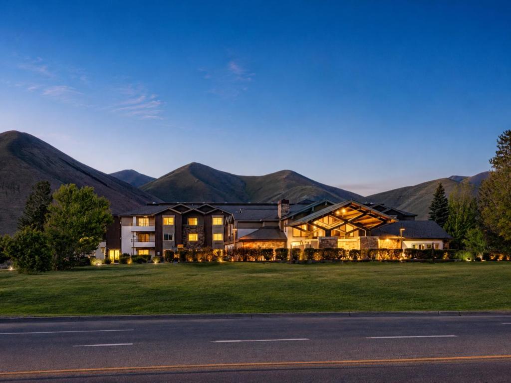 a large building with mountains in the background at Hampton Inn By Hilton Hailey Sun Valley in Hailey