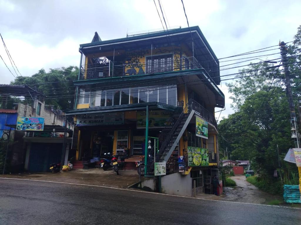 a building with a balcony on the side of a street at K K Kumar Guest in Norwood