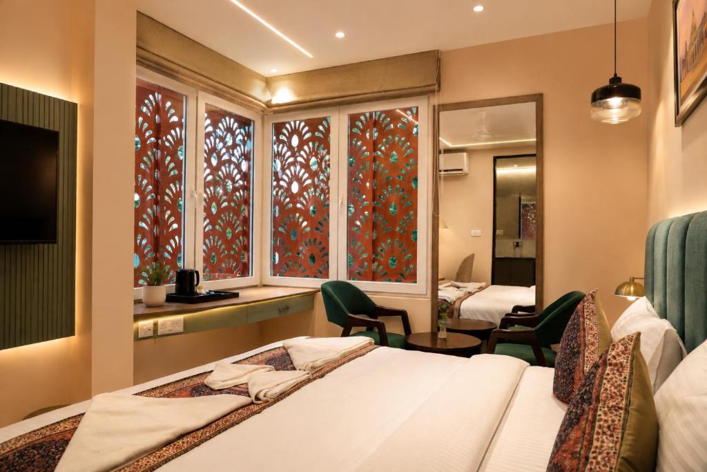 a hotel room with a bed and a window at Hotel Anant Inn in Varanasi