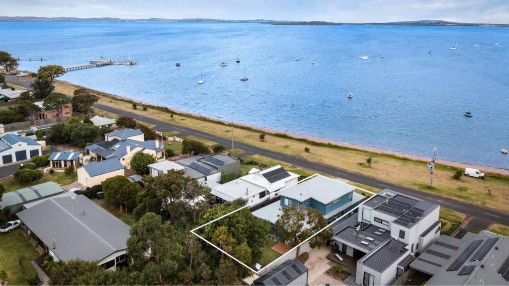 an aerial view of a beach with houses and the water at Pukeko Beach House in Rhyll