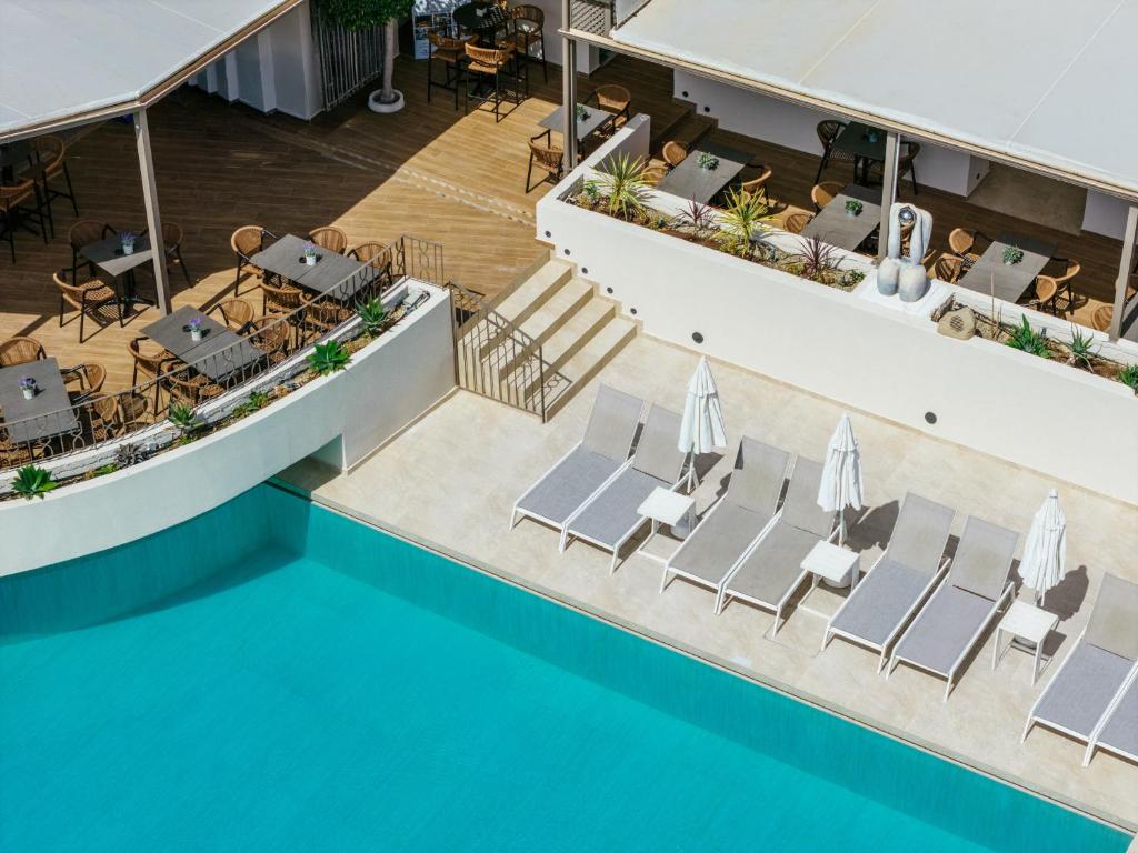an overhead view of a pool with chairs and tables at Diana Palace Hotel Zakynthos in Argassi