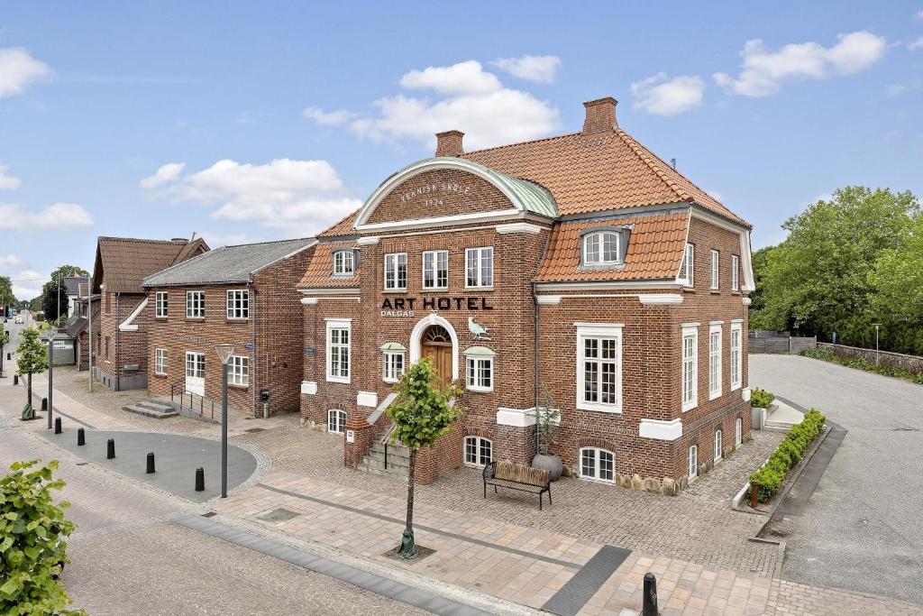 a large red brick building on a street at ART Hotel Dalgas, BW Signature Collection in Brande