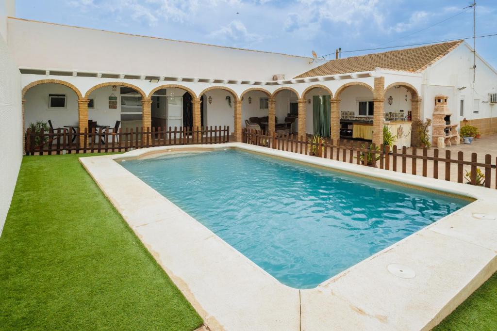 an image of a swimming pool in front of a house at El Llano in Sierra de Yeguas